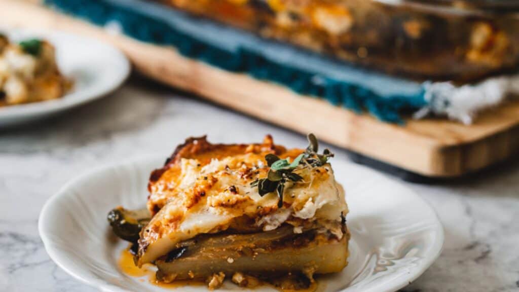 A dish of lasagna on a white plate.