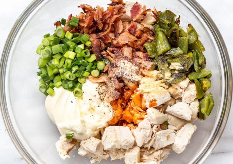 A bowl full of ingredients for jalapeño popper chicken salad.