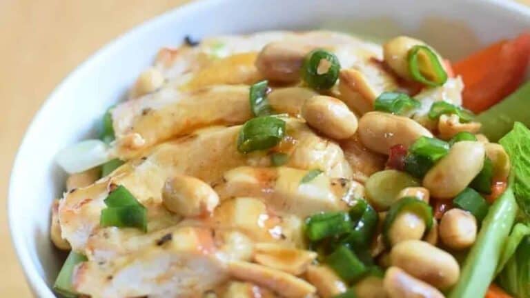 Image shows a closeup of Kung Pao Chicken Salad in a white bowl.