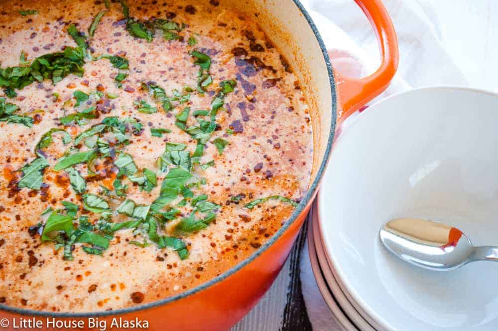 A warm pot of tomato soup, perfect for cozy winter dinners.