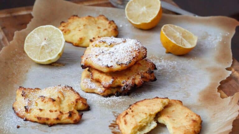 Lemon cookies with powdered sugar and lemon slices.