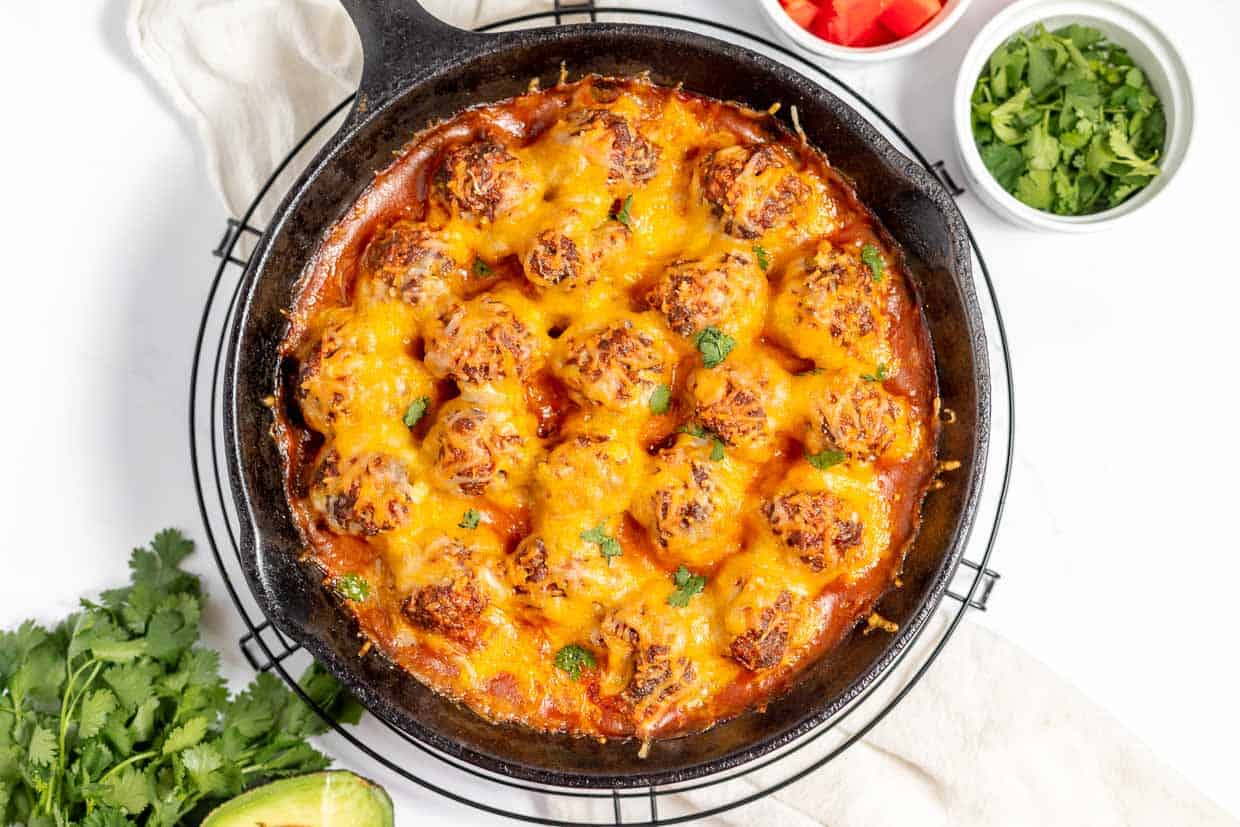 Cheesy mexican meatballs in a skillet.