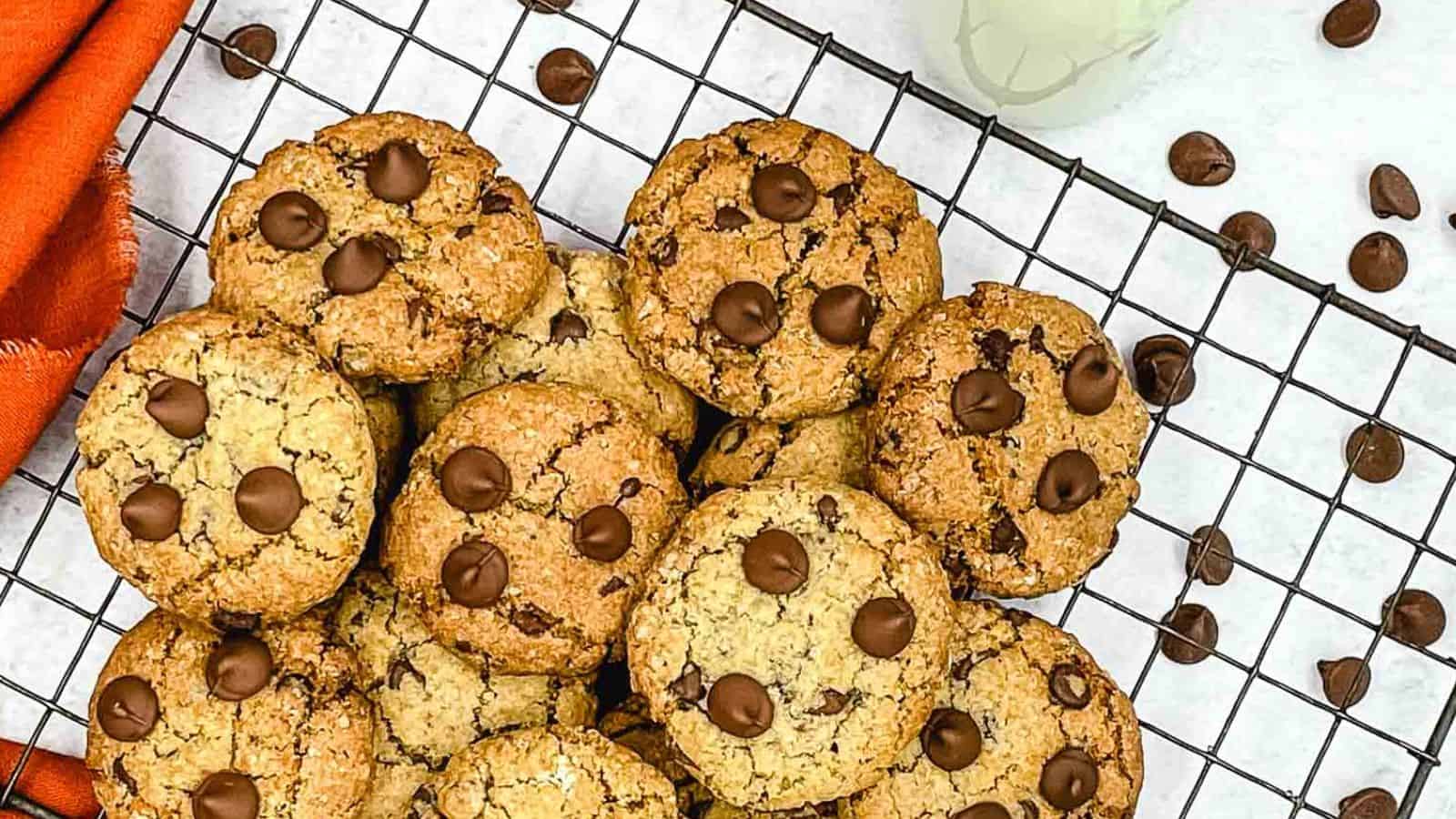 Oatmeal Chocolate Chip Cookies on a cooling rack with a glass of milk.