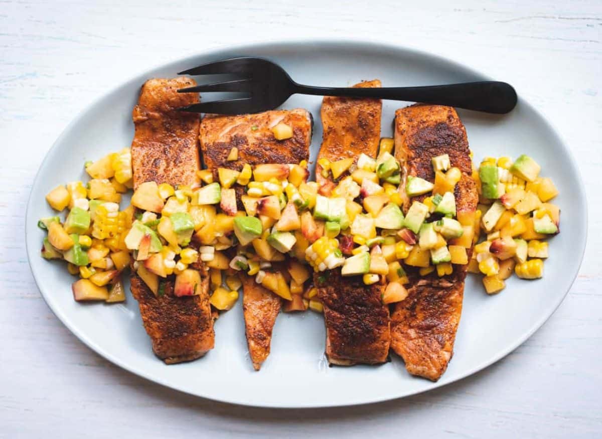 A plate with Old Bay Salmon with Peach Avocado Salsa.