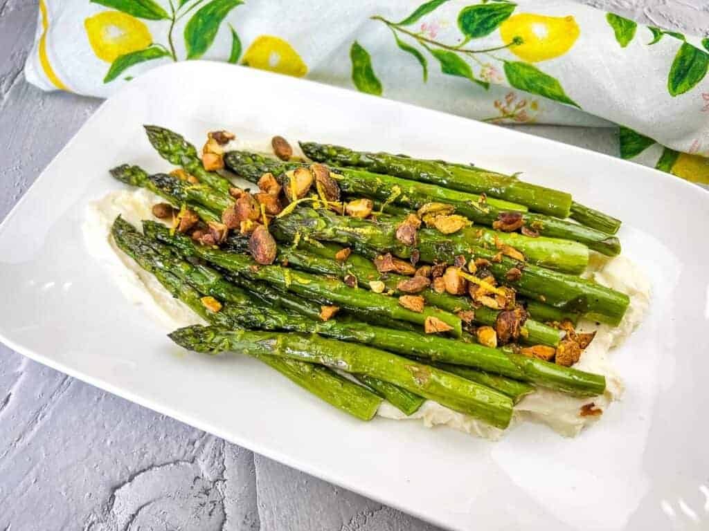 A plate of asparagus with mascarpone and lemon.