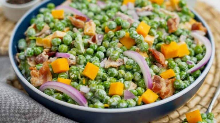 Pea salad in a blue bowl.