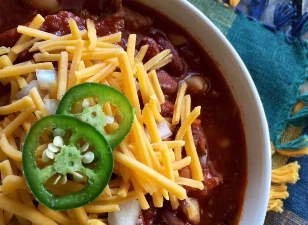 slow cooker chili topped with sliced jalepenos