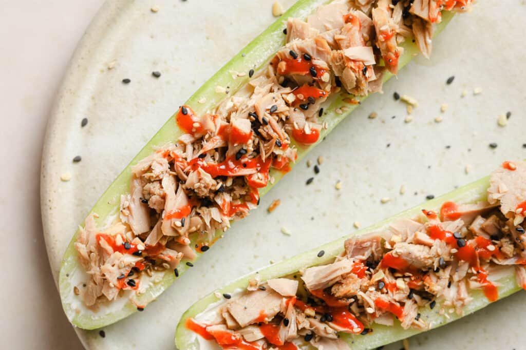 Two cucumber boats with tuna and sesame seeds.