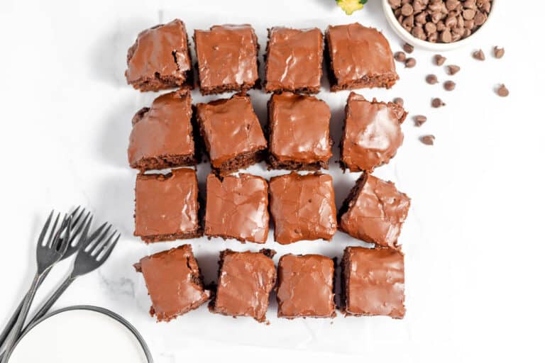 Decadent chocolate brownies on a white plate, perfect for winter dinners.