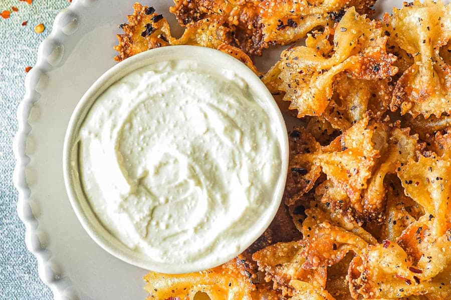 Top view of whipped feta and pasta chips.