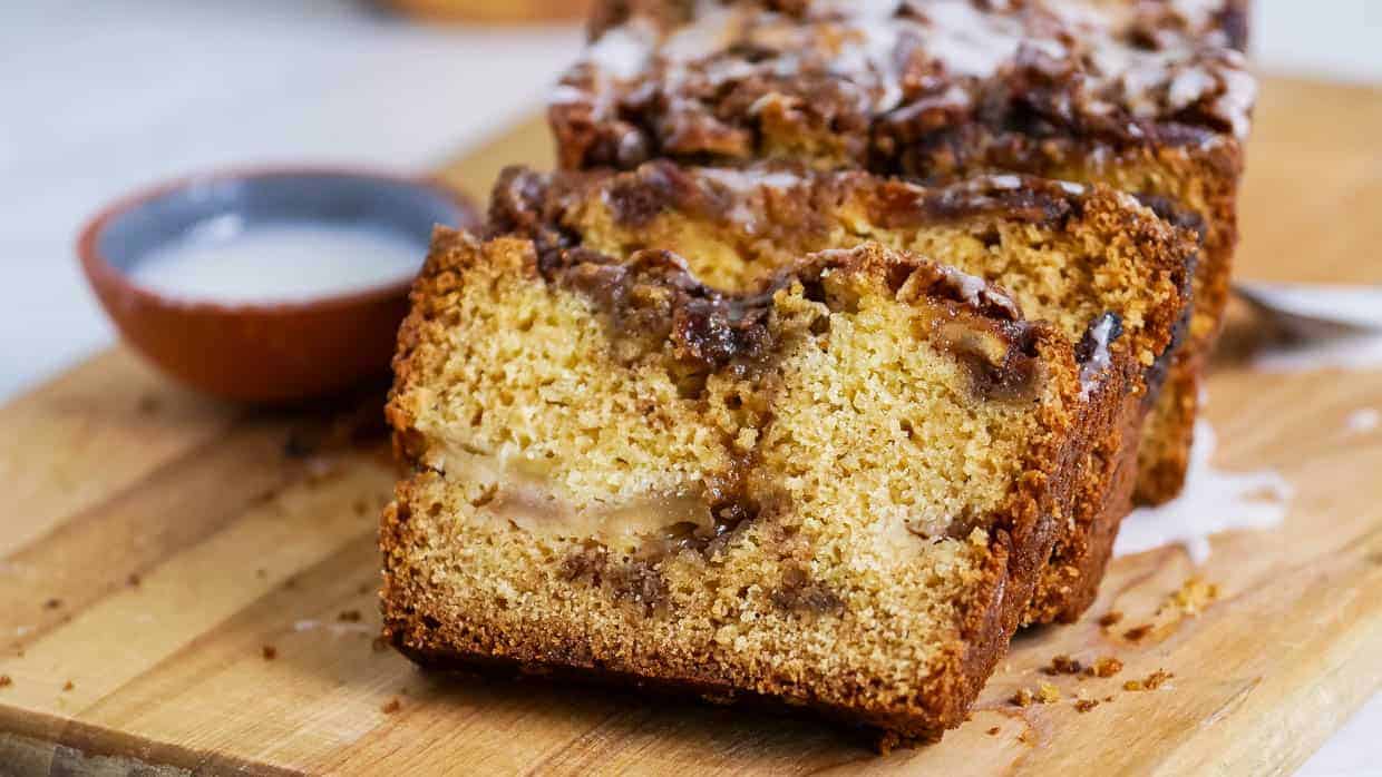 A slice of apple cinnamon bread on a cutting board.