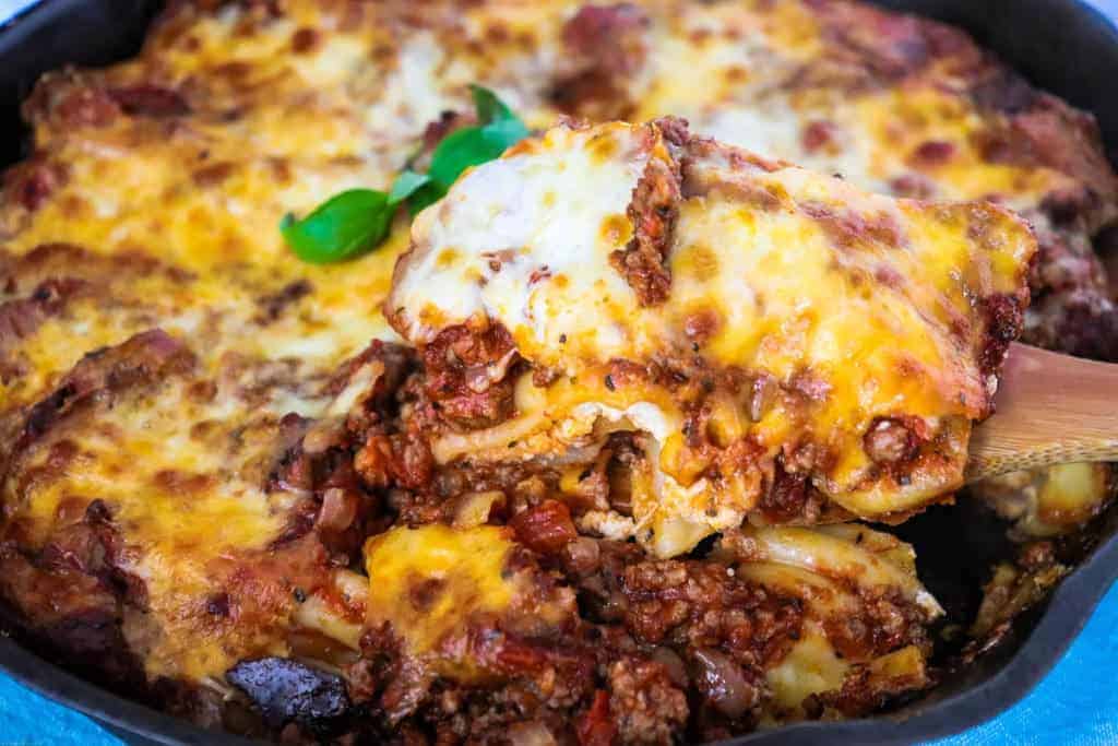 Baked manicotti in a cast iron skillet.