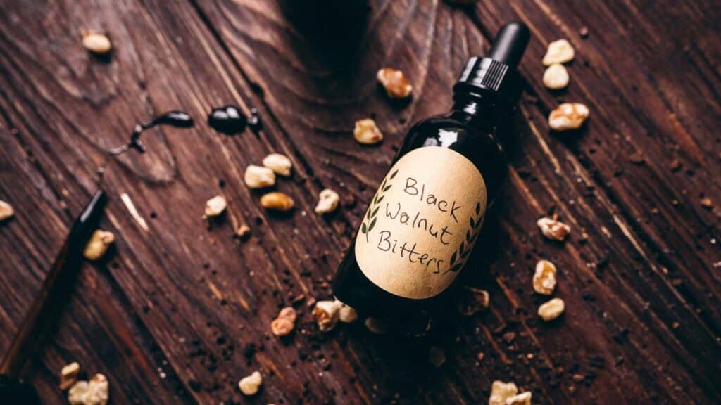 An artisanal bottle of black walnut oil on a rustic wooden table.