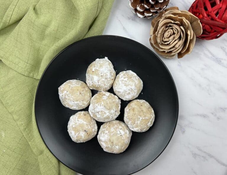 A black plate with pecan butter pecan cookies.