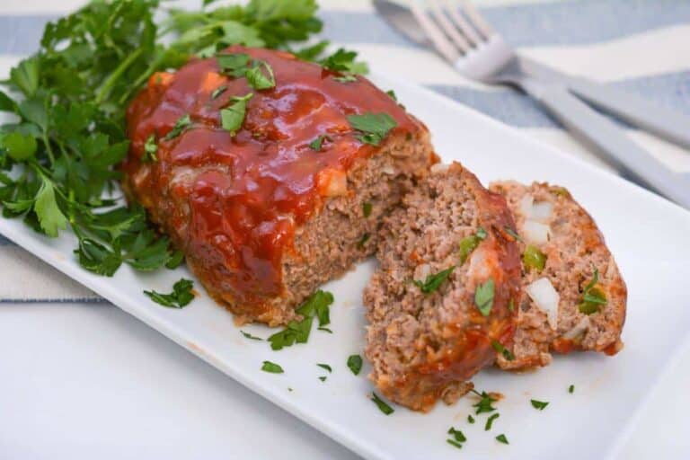 Meatloaf on a white plate with a fork.