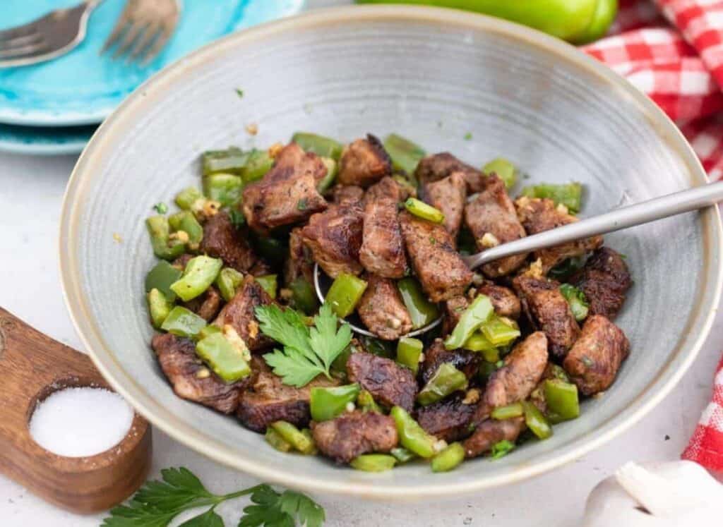 Garlic butter steak bites with a spoon in a bowl.