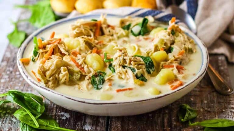 Chicken gnocchi soup in a white bowl.