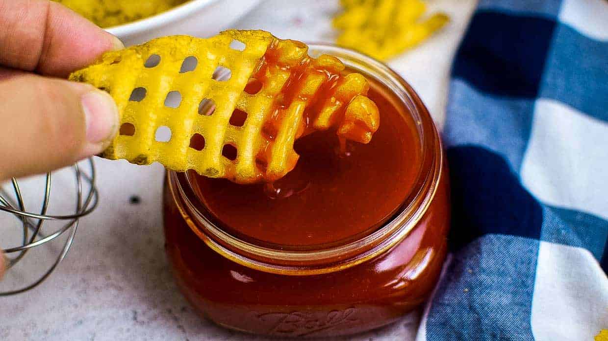 Dipping a waffle fry into copycat Polynesian sauce.