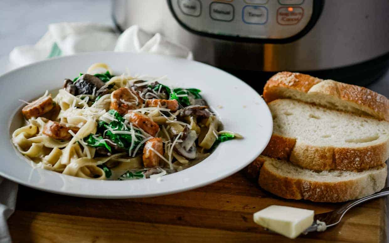 A bowl of pasta and bread prepared with an instant pot.