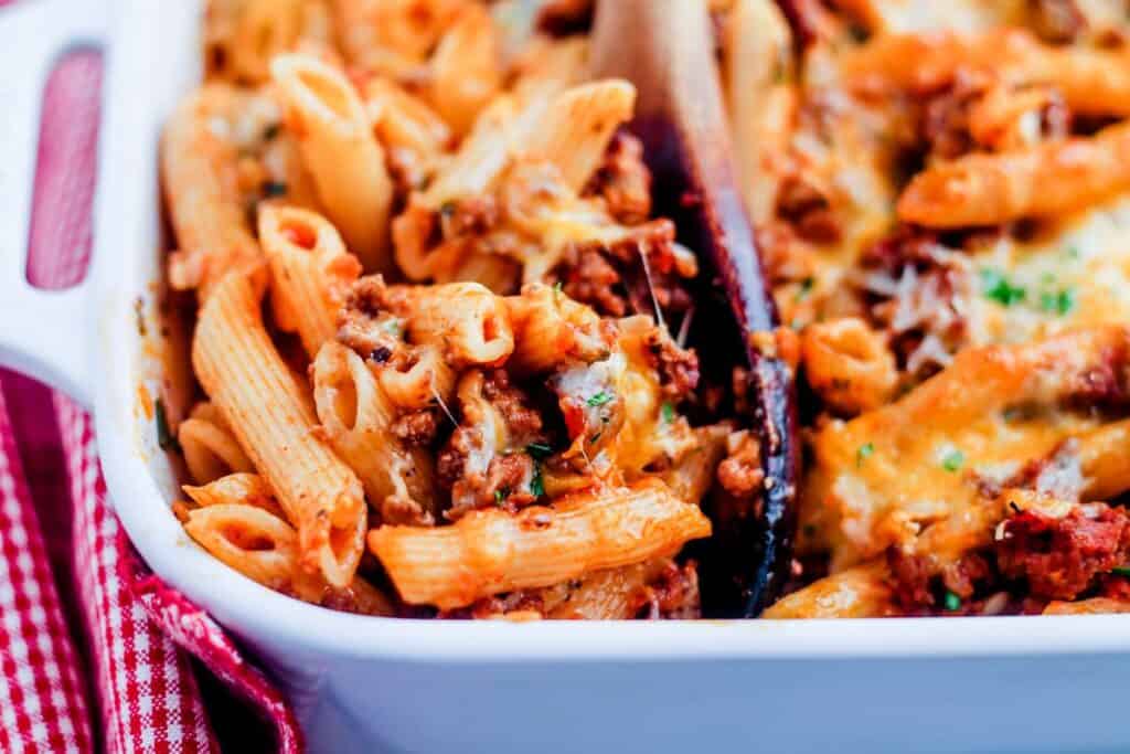 A casserole dish with pasta and meat in it.