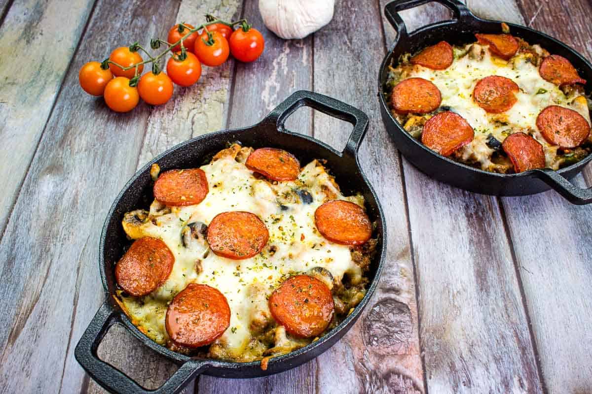 Two skillets filled with pepperoni and tomatoes.