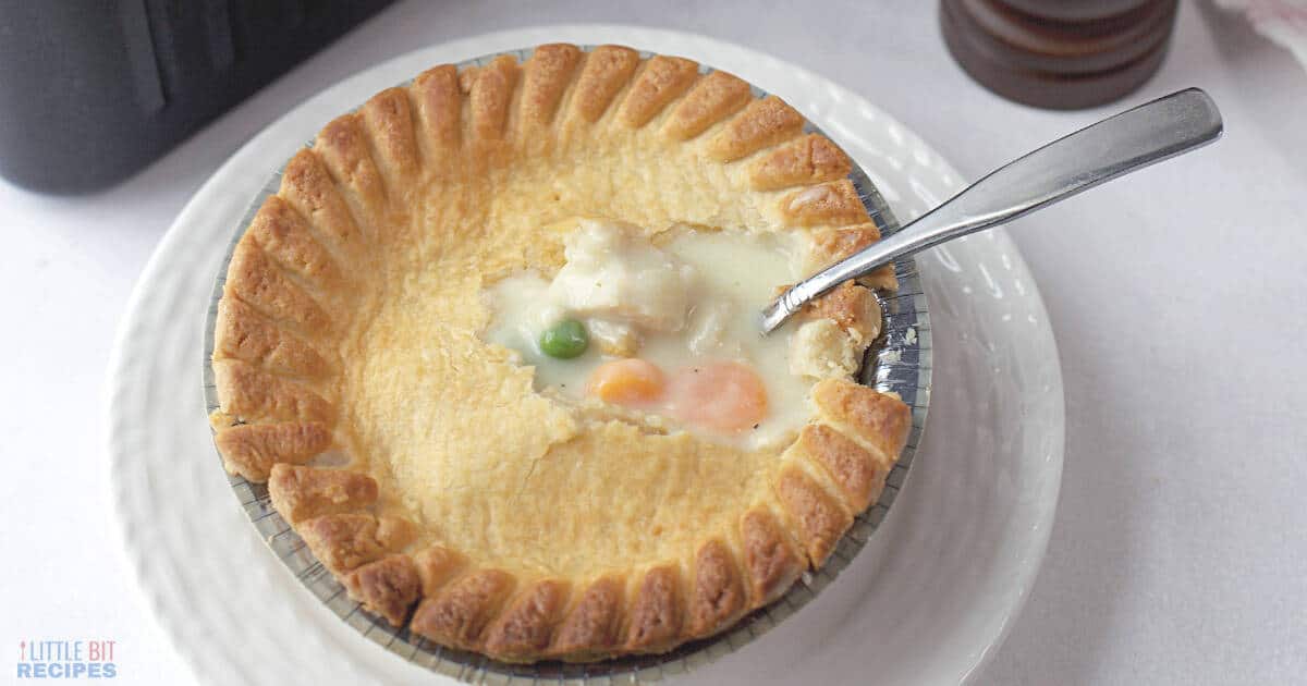 Pot pie on plate with fork in middle.