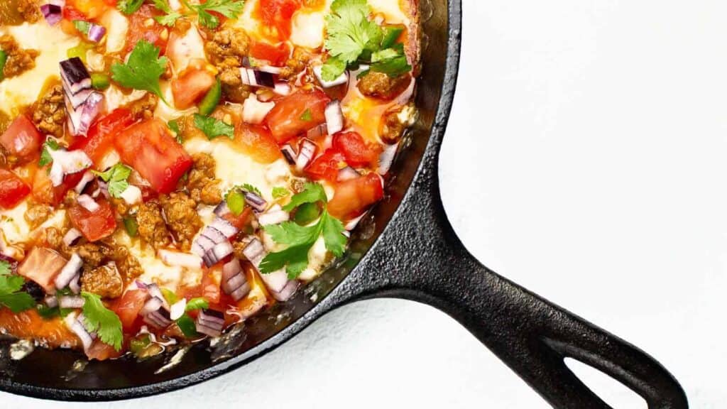 A skillet filled with meat and vegetables.