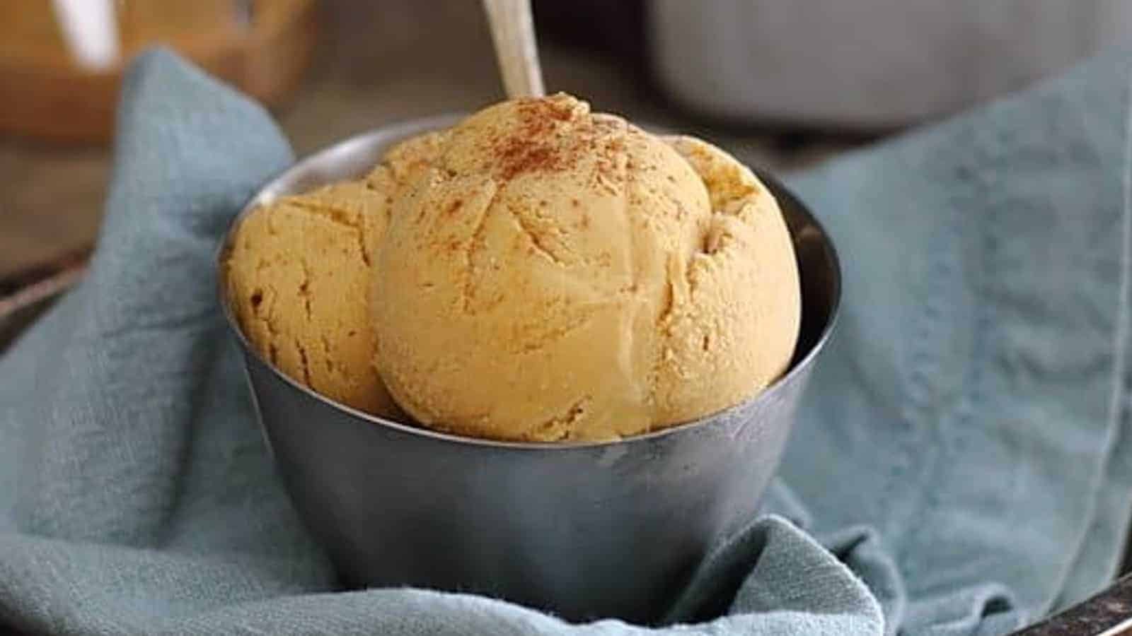 Sweet potato ice cream in a metal bowl with a spoon.