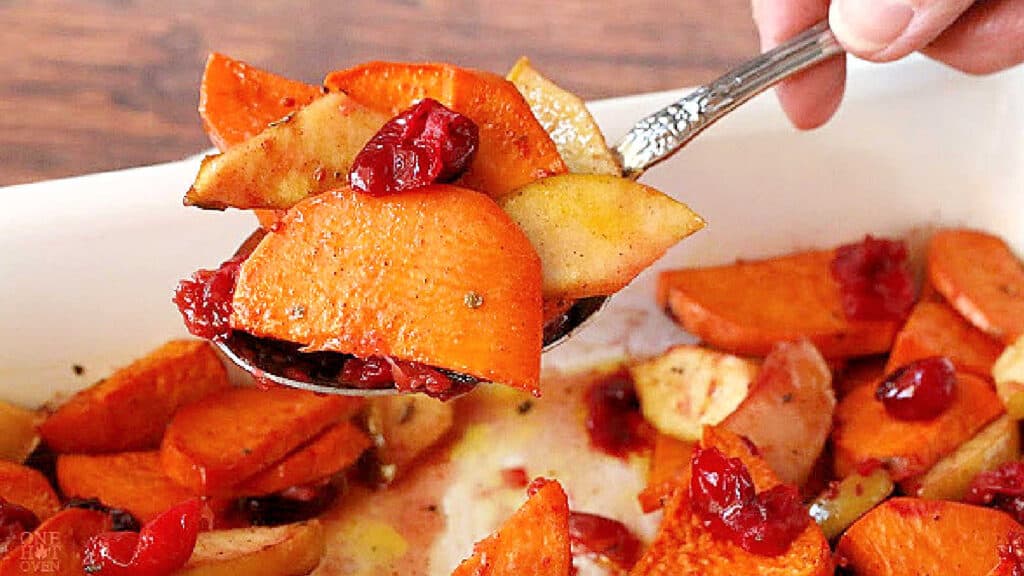 Sweet potatoes with cranberries in a baking dish.