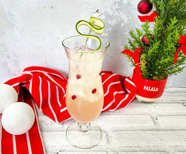 A festive holiday cocktail featuring cranberries and a Christmas tree garnish to be enjoyed all season long.