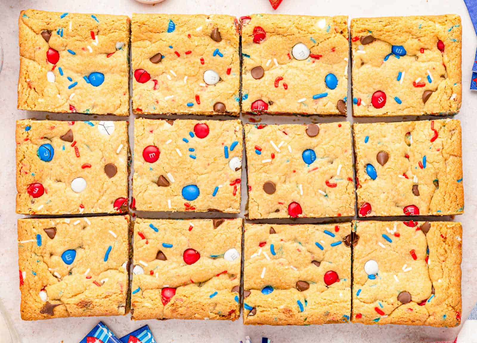 M&M sugar cookie bars cut into squares.