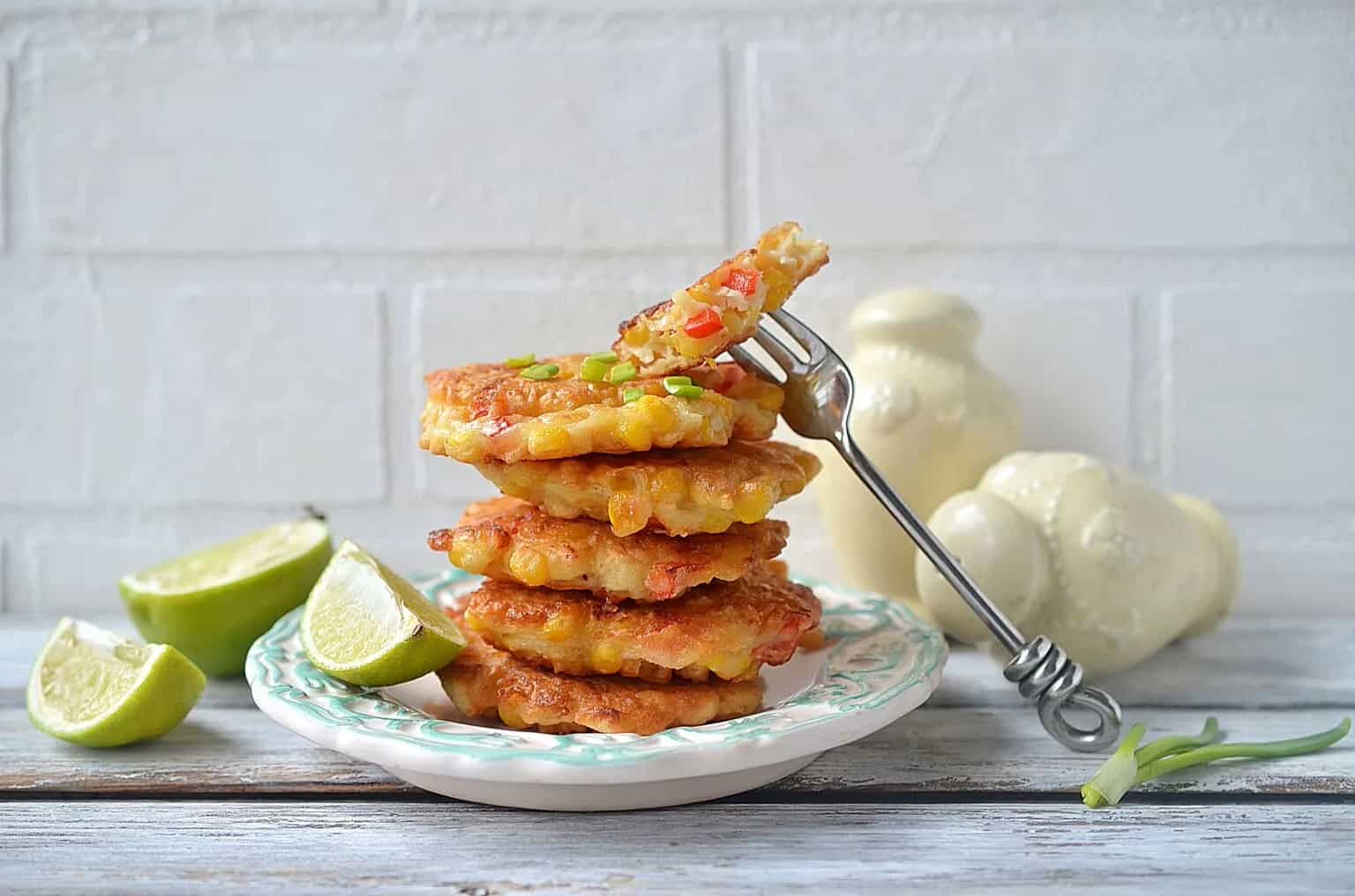 Stack of Mexican corn cakes on a white plate with a fork.