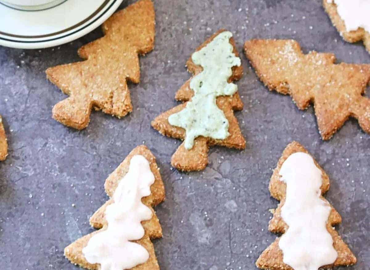 Gingerbread tree cookies with icing and a cup of coffee.