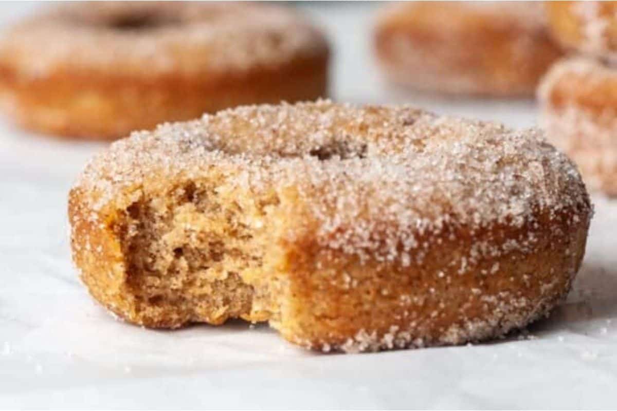 Cinnamon sugar donuts with a bite taken out.