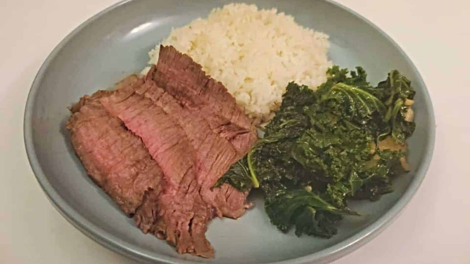 Asian marinated steak on a plate with sides.