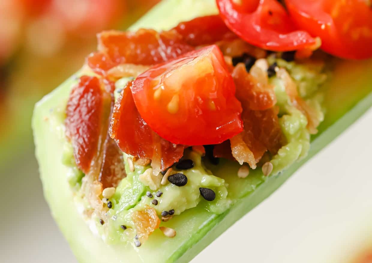 A plate of bacon tomato avocado cucumber boats.