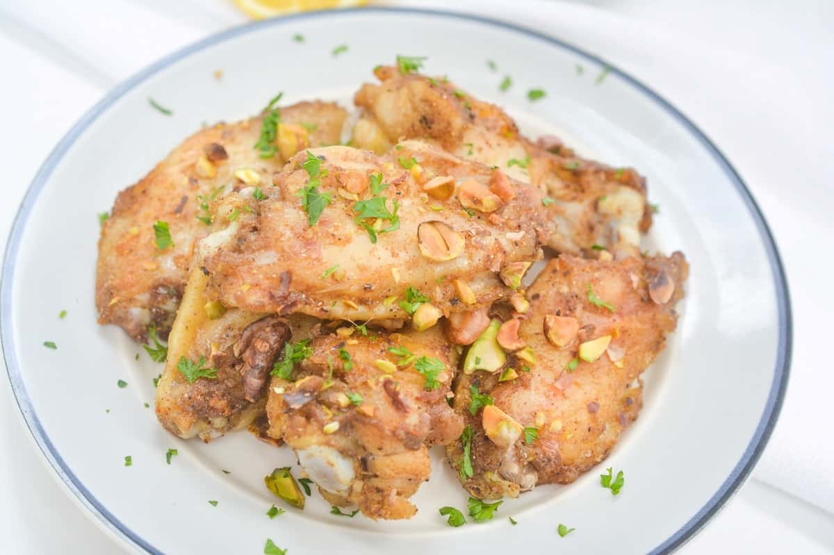 Chicken wings on a plate with parsley.