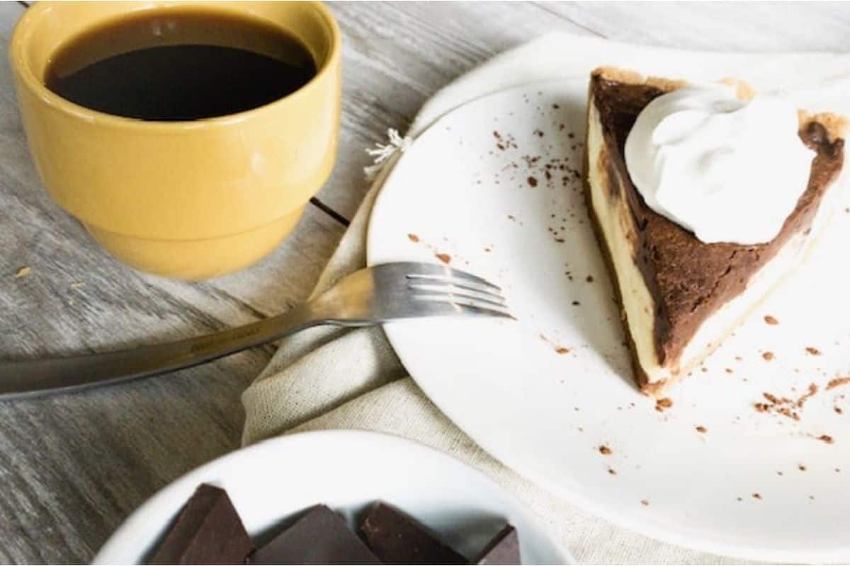 A slice of chocolate pie and a cup of coffee.