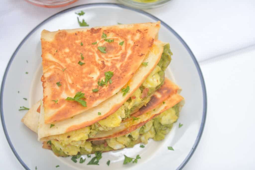 A stack of quesadillas on a plate.