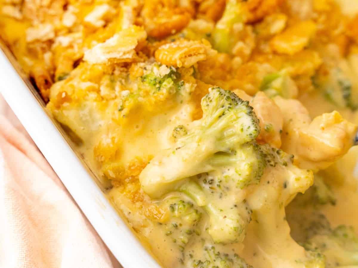 Close up of broccoli casserole in a serving dish with cracker crumbs on top.