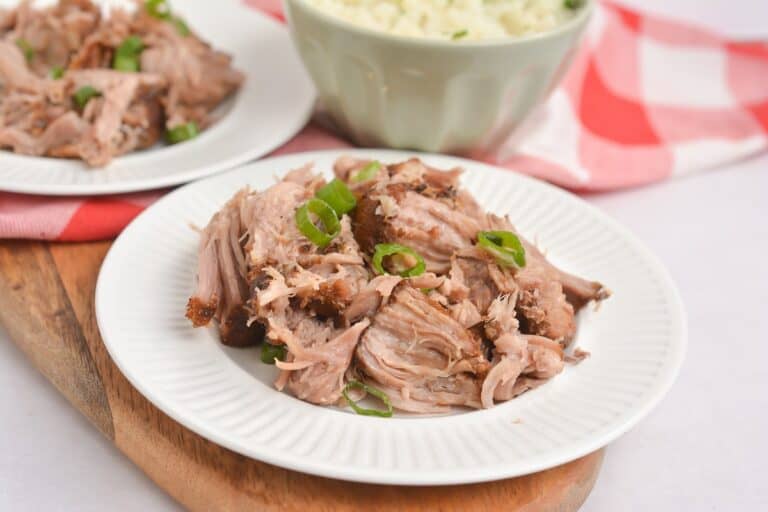 Shredded pork on a white plate.