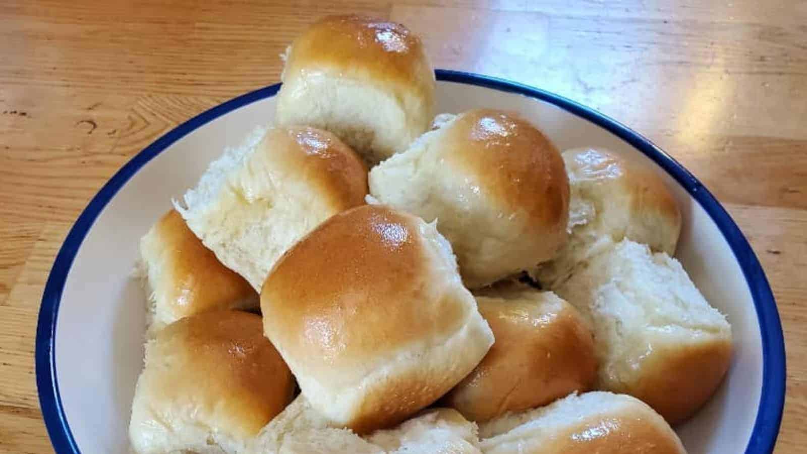 Image shows a bowl filled with Buttery Dinner Rolls.