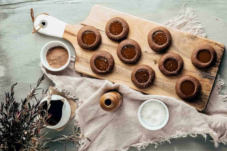 Chocolate cookies on a wooden cutting board.