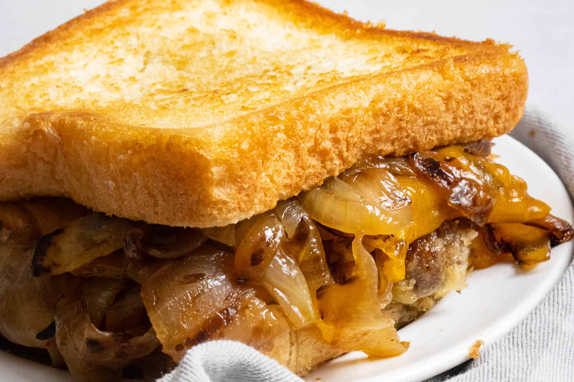 An easy grilled sandwich with onions and cheese on a plate.