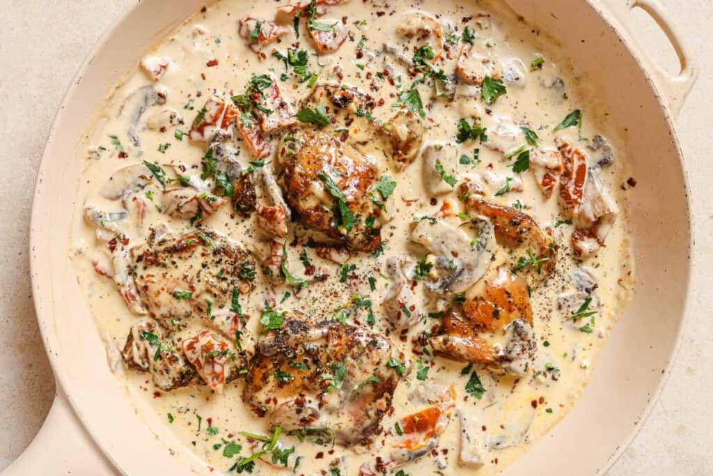 Chicken with creamy mushroom sauce in a skillet.