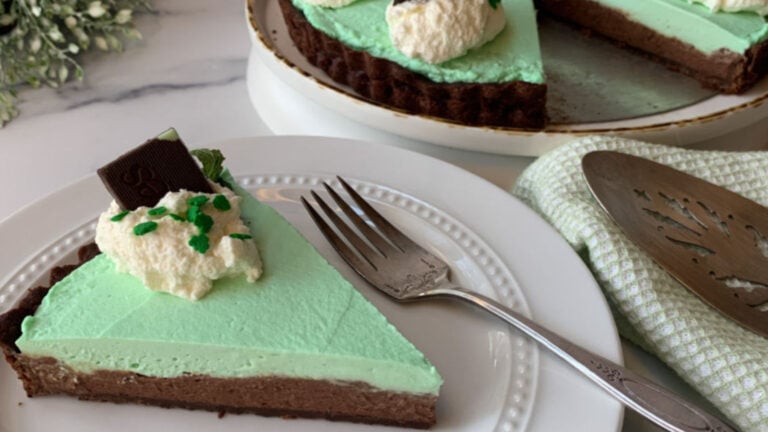 A slice of chocolate mint tart on a white plate.