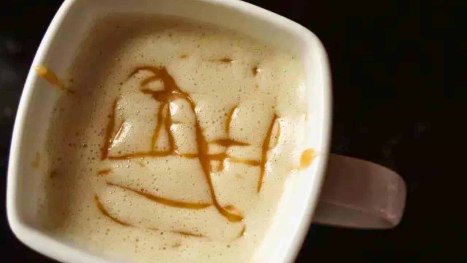 Image shows an overhead closeup shot of a mug with a Copycat Caramel Macchiato.