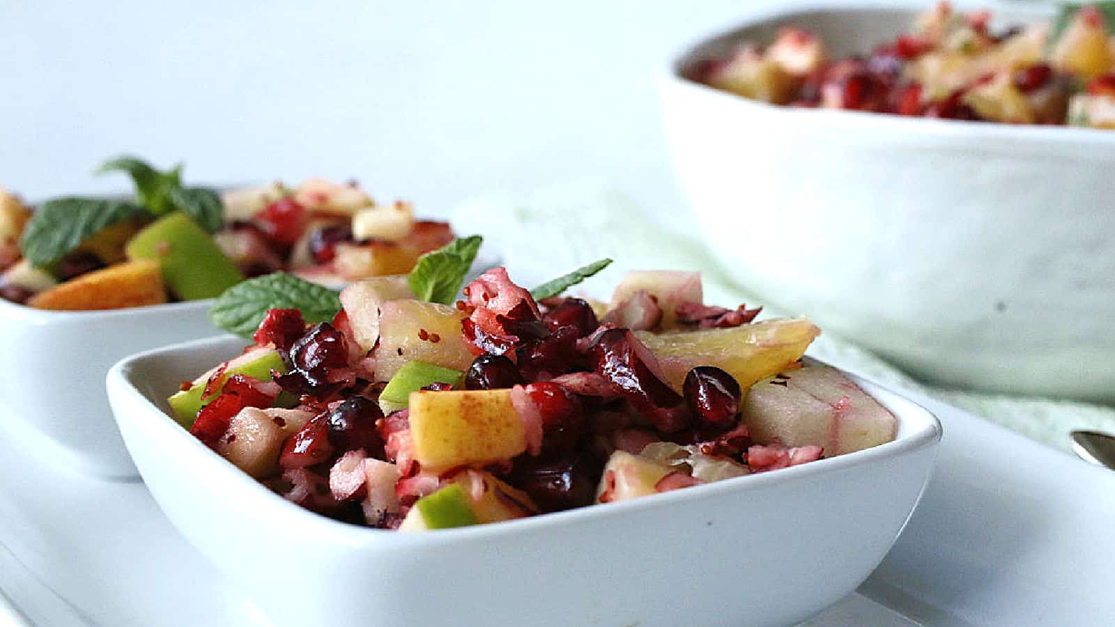 Cranberry fruit salad in white bowls.