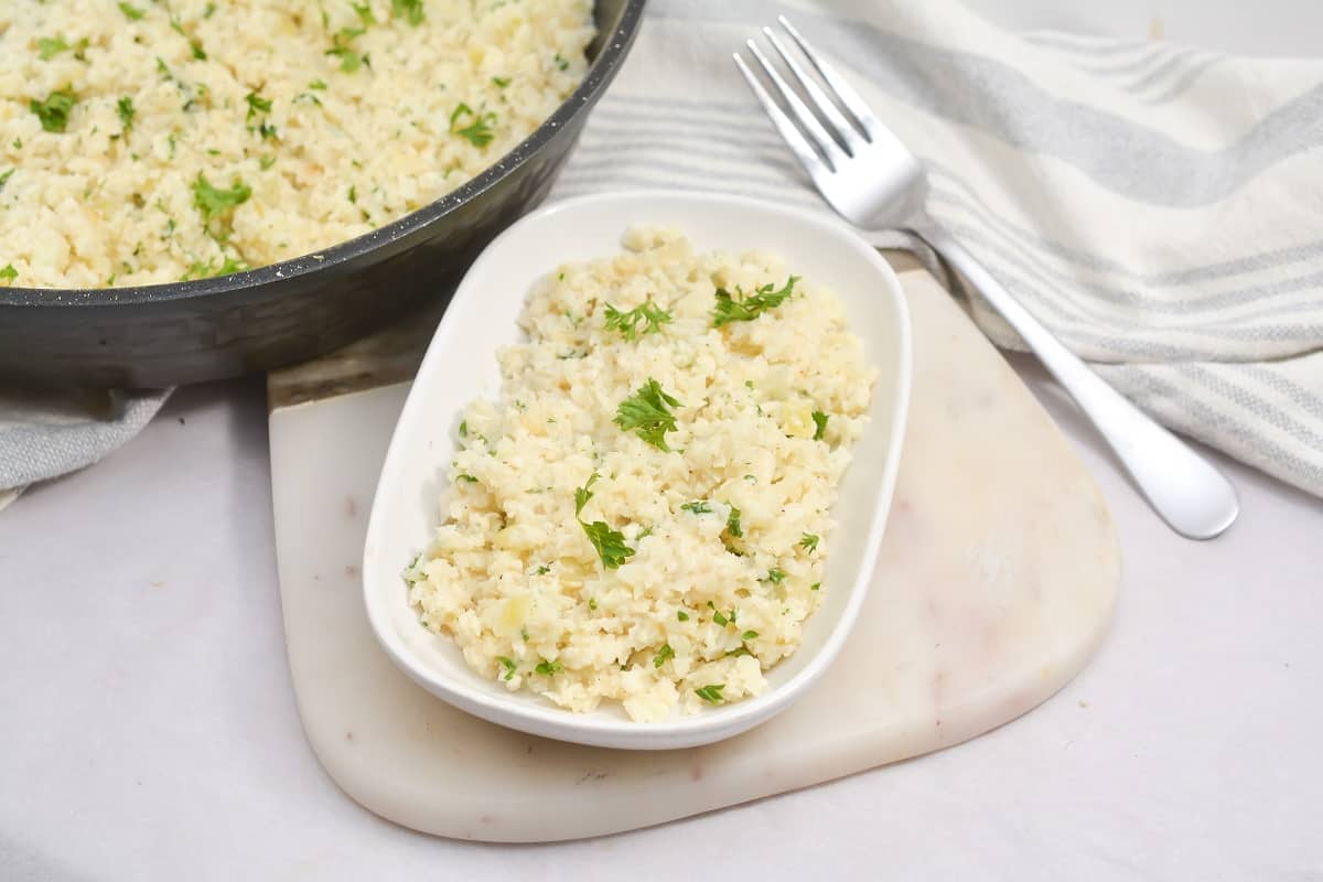 Creamy Risotto in a white bowl next to a fork.