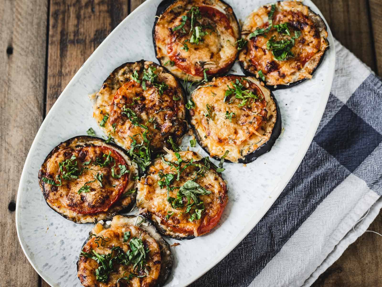 Eggplant tomato stacks with grilled eggplant slices and tomato layers.